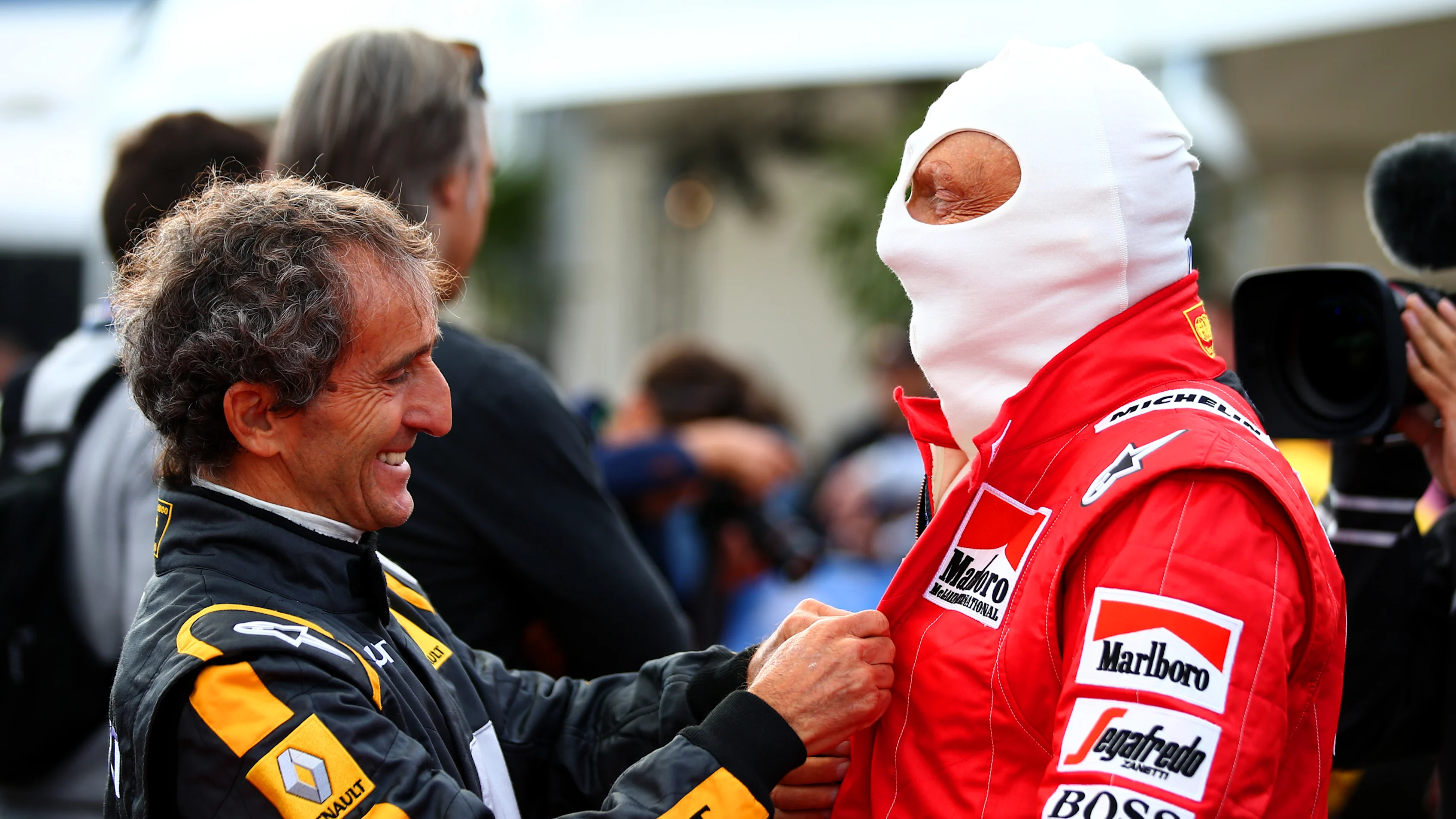 SPIELBERG, AUSTRIA - JUNE 20: Former driver Alain Prost helps Niki Lauda prepare on track after